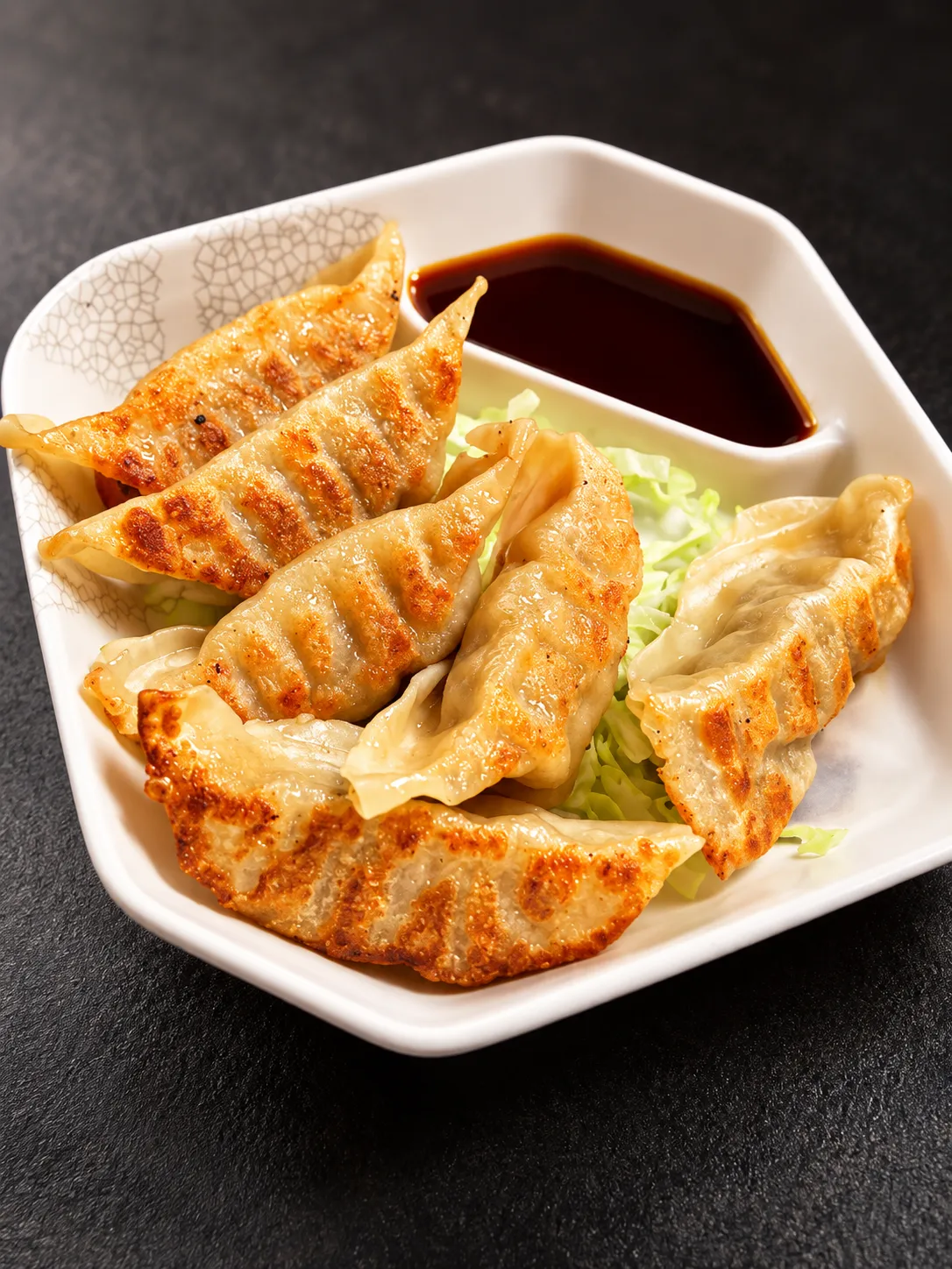 Pan-fried gyoza with dipping sauce at Tougen
