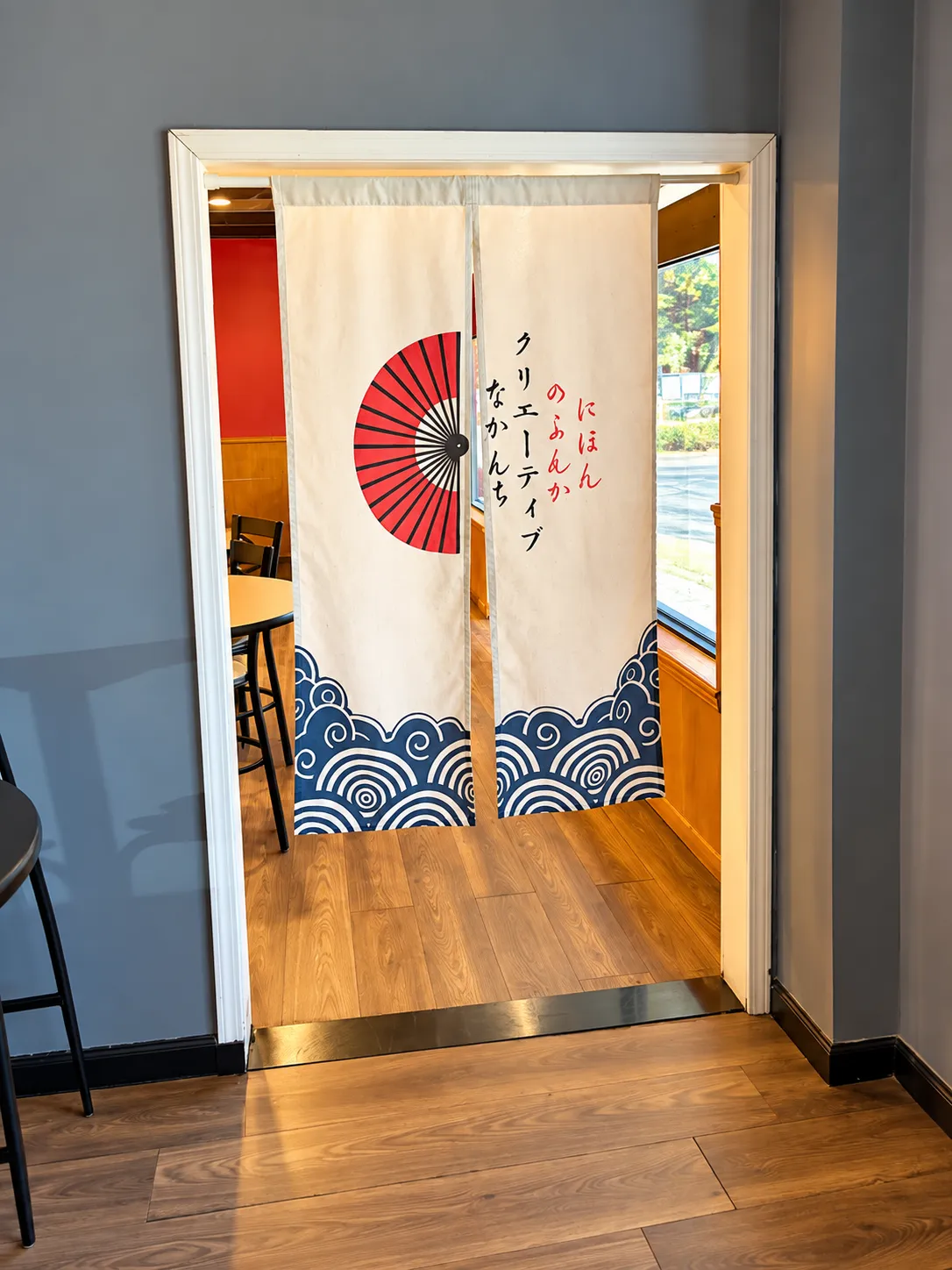 Fan-printed noren curtain at a doorway at Tougen