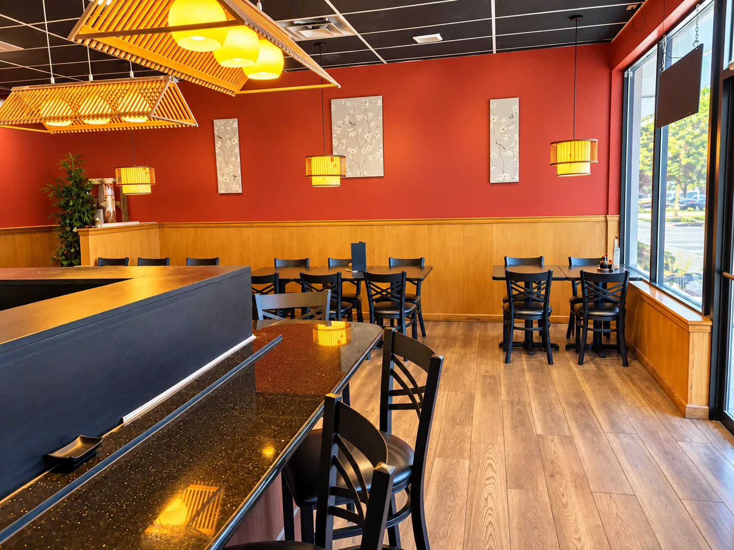 Warm red dining room with bamboo lanterns and blossom panels at Tougen