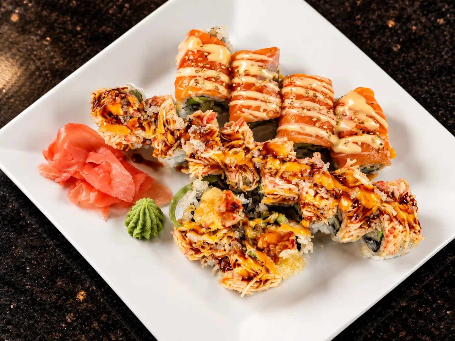 Salmon-topped and crab-topped specialty rolls at Tougen
