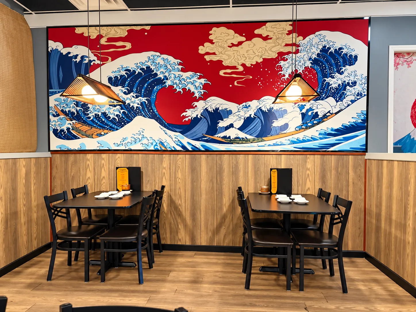 Great wave mural over two dining tables